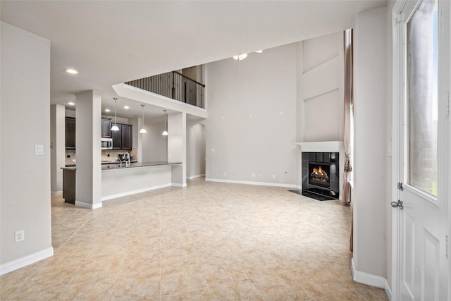 5227 Birch Falls Ln, Sugar Land, TX 77479 - unfurnished living room with a tile fireplace, recessed lighting, and light tile patterned flooring