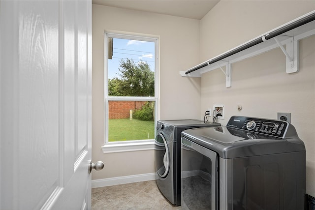 5227 Birch Falls Ln, Sugar Land, TX 77479 - laundry area with washer and clothes dryer, healthy amount of natural light, and light tile patterned floors