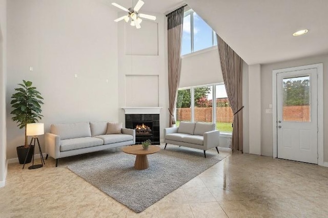 5227 Birch Falls Ln, Sugar Land, TX 77479 - tiled living area with a high ceiling, plenty of natural light, a tile fireplace, and ceiling fan