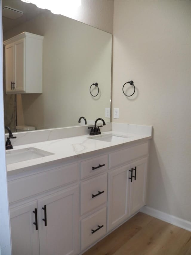 4218 Sorsby Dr, Houston, TX 77047 - bathroom featuring double vanity and wood finished floors