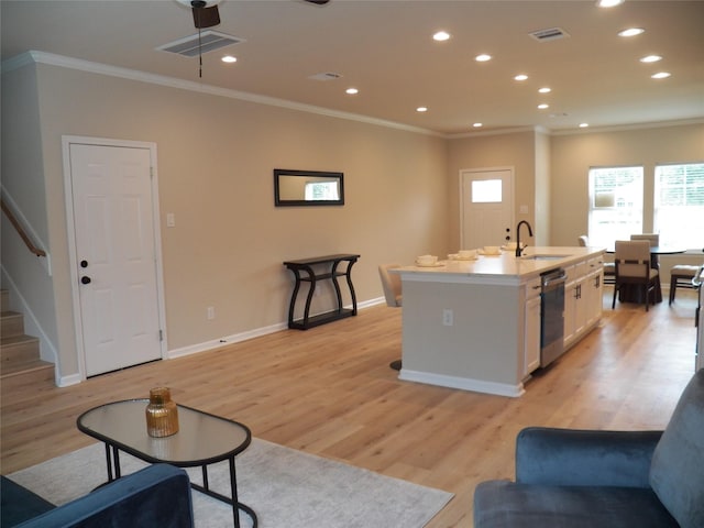 4218 Sorsby Dr, Houston, TX 77047 - living room featuring ornamental molding, recessed lighting, light wood finished floors, and stairs