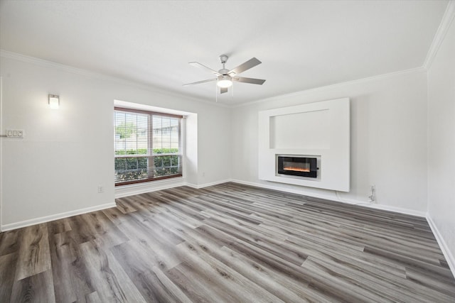 6451 Olympia Dr Unit 96, Houston, TX 77057 - unfurnished living room featuring ornamental molding, wood finished floors, a ceiling fan, and a glass covered fireplace
