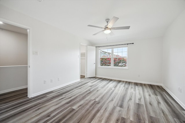 6451 Olympia Dr Unit 96, Houston, TX 77057 - unfurnished bedroom with wood finished floors, a closet, a ceiling fan, and a walk in closet