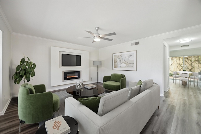 6451 Olympia Dr Unit 96, Houston, TX 77057 - living area with wood finished floors, a glass covered fireplace, ceiling fan, and ornamental molding