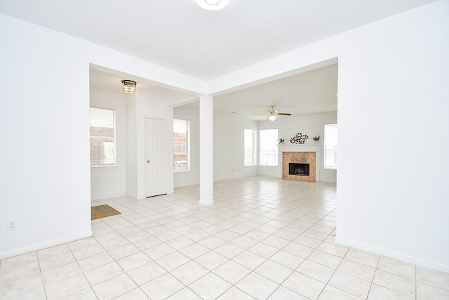 9338 Corner Oak Ln, Houston, TX 77036 - unfurnished living room featuring ceiling fan, a fireplace, and light tile patterned flooring