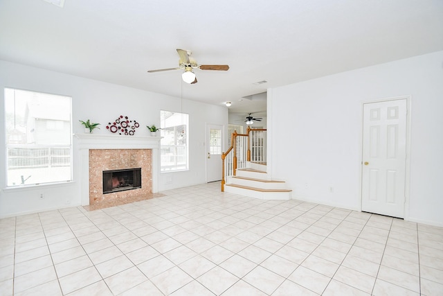 9338 Corner Oak Ln, Houston, TX 77036 - unfurnished living room featuring ceiling fan, healthy amount of natural light, stairway, and a tile fireplace
