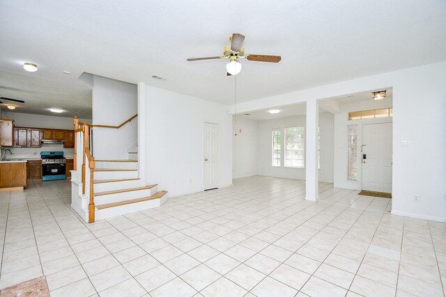 9338 Corner Oak Ln, Houston, TX 77036 - unfurnished living room with a ceiling fan and stairway