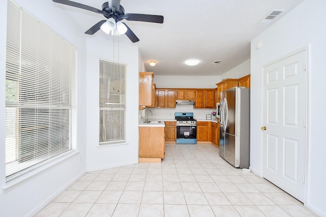 9338 Corner Oak Ln, Houston, TX 77036 - kitchen with appliances with stainless steel finishes, under cabinet range hood, light countertops, and healthy amount of natural light
