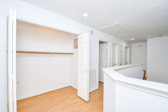 9338 Corner Oak Ln, Houston, TX 77036 - corridor featuring attic access, light wood-style flooring, an upstairs landing, and recessed lighting