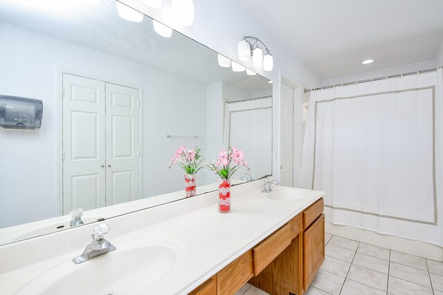 9338 Corner Oak Ln, Houston, TX 77036 - bathroom with double vanity, tile patterned flooring, a shower with curtain, and recessed lighting