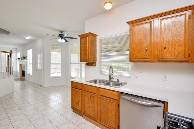 9338 Corner Oak Ln, Houston, TX 77036 - kitchen with dishwasher, light countertops, a ceiling fan, light tile patterned flooring, and a fireplace