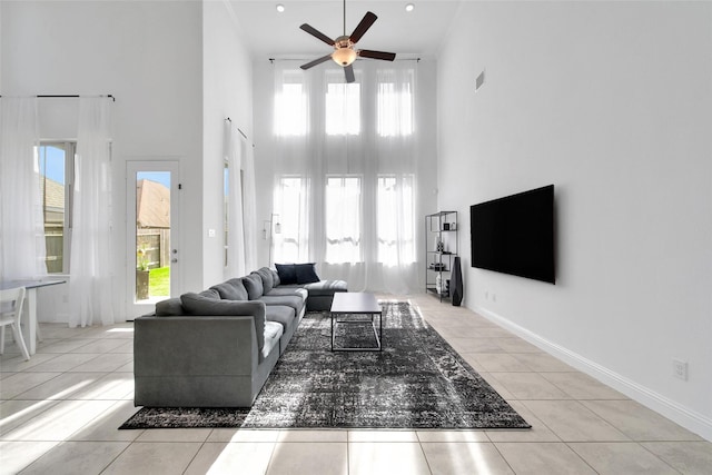 3310 Bellwick Chase Ln, Houston, TX 77365 - living room featuring a towering ceiling, a ceiling fan, and light tile patterned floors