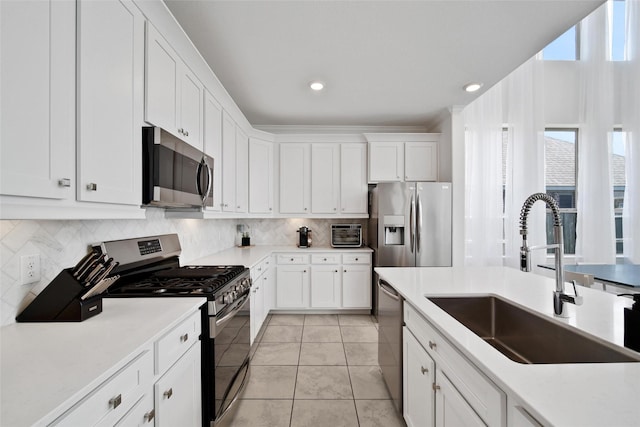 3310 Bellwick Chase Ln, Houston, TX 77365 - kitchen featuring stainless steel appliances, white cabinetry, tasteful backsplash, light tile patterned floors, and light countertops
