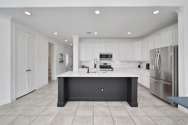 3310 Bellwick Chase Ln, Houston, TX 77365 - kitchen featuring stainless steel appliances, light countertops, a kitchen island with sink, white cabinets, and light tile patterned flooring
