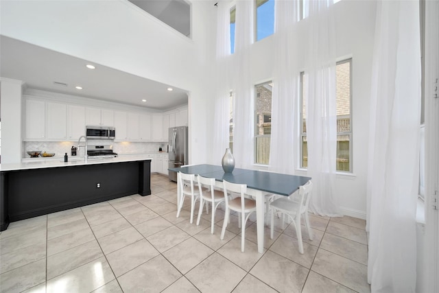 3310 Bellwick Chase Ln, Houston, TX 77365 - dining area with light tile patterned floors, recessed lighting, and a towering ceiling