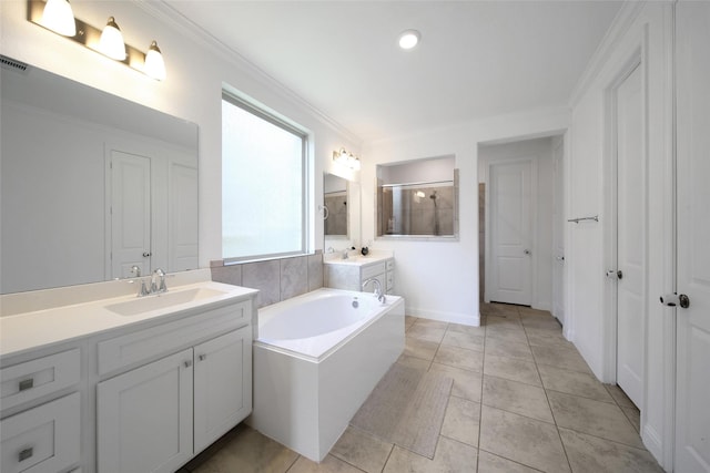 3310 Bellwick Chase Ln, Houston, TX 77365 - bathroom featuring vanity, a garden tub, a shower stall, tile patterned floors, and crown molding