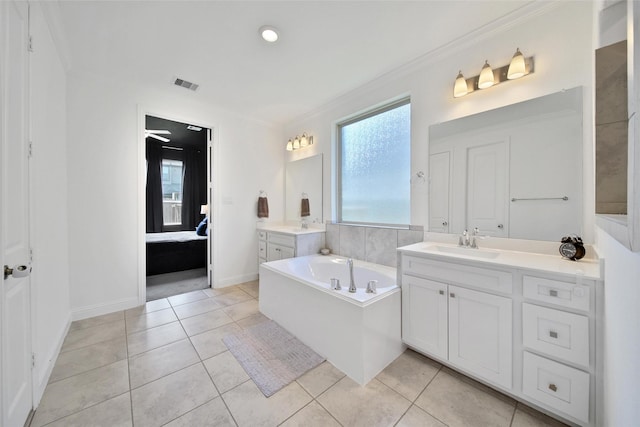 3310 Bellwick Chase Ln, Houston, TX 77365 - bathroom featuring two vanities, a garden tub, crown molding, ensuite bathroom, and tile patterned floors