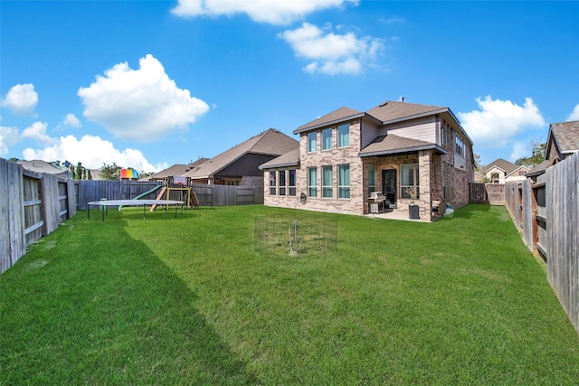 3310 Bellwick Chase Ln, Houston, TX 77365 - back of property with a fenced backyard, roof with shingles, a patio area, and brick siding