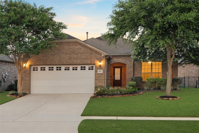 207 Cattle Ranch Dr, Richmond, TX 77469 - view of front facade with brick siding, concrete driveway, a shingled roof, and an attached garage