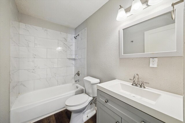 3209 Mccrarey Dr, Houston, TX 77088 - full bathroom featuring a textured wall, vanity, tub / shower combination, and wood finished floors