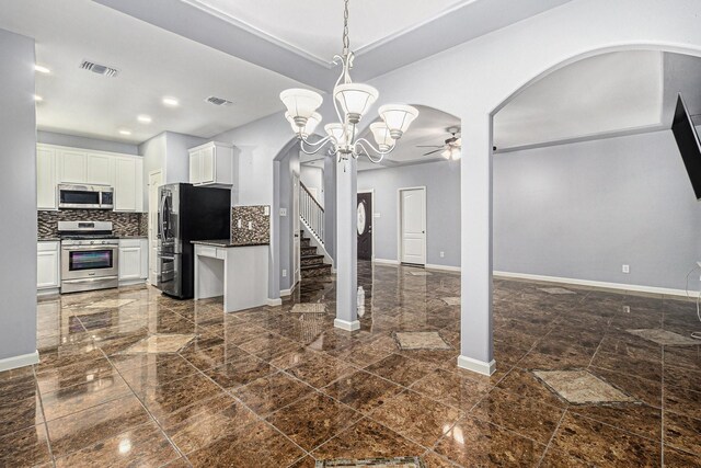12222 Warrenwood Dr, Houston, TX 77066 - kitchen featuring stainless steel appliances, a ceiling fan, dark countertops, white cabinetry, and decorative backsplash