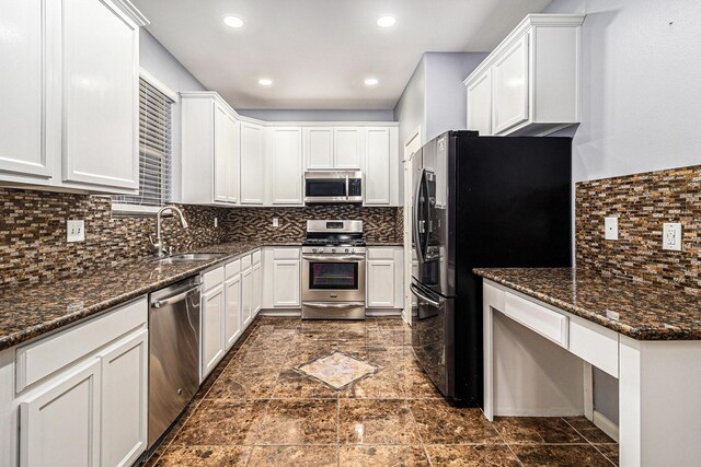 12222 Warrenwood Dr, Houston, TX 77066 - kitchen with appliances with stainless steel finishes, decorative backsplash, white cabinets, and recessed lighting