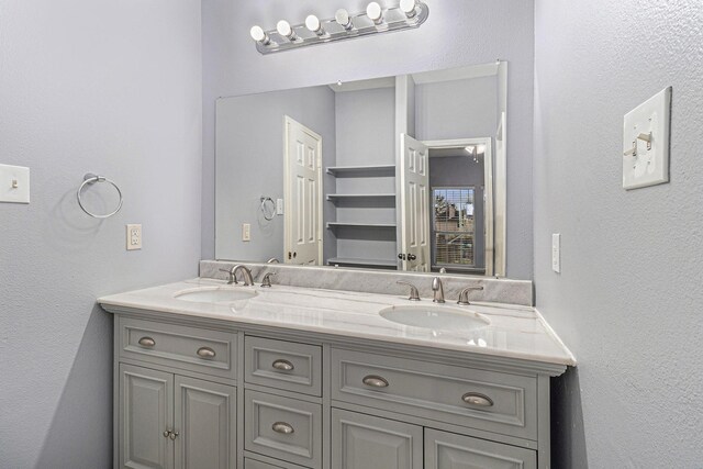 12222 Warrenwood Dr, Houston, TX 77066 - full bathroom with double vanity and a textured wall