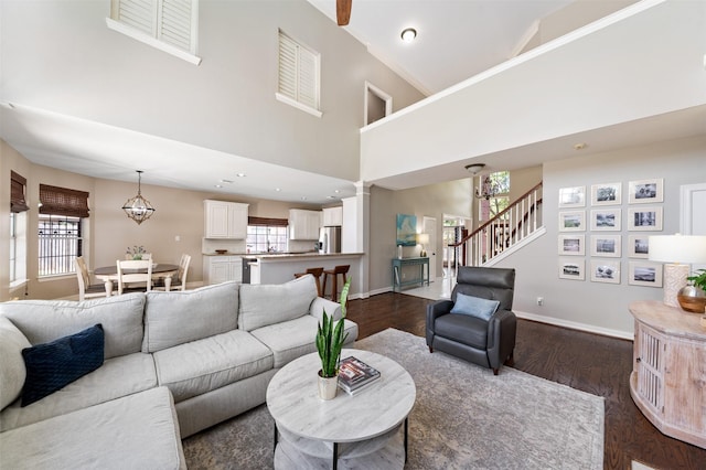 16047 Lockdale Ln, Cypress, TX 77429 - living area featuring dark wood-style flooring, stairs, and a towering ceiling