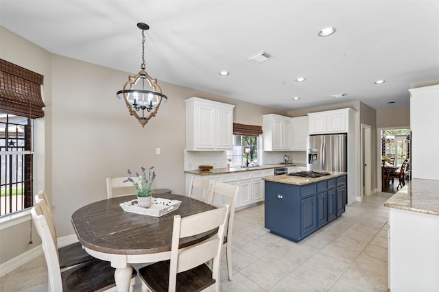 16047 Lockdale Ln, Cypress, TX 77429 - kitchen featuring stainless steel refrigerator with ice dispenser, blue cabinets, white cabinetry, a chandelier, and recessed lighting