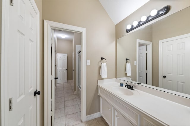 16047 Lockdale Ln, Cypress, TX 77429 - bathroom featuring vanity, vaulted ceiling, tile patterned flooring, and shower / bath combination with glass door