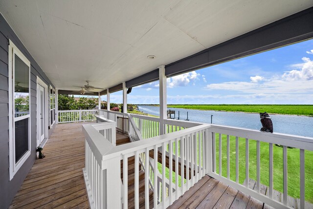 10102 S Redfish Dr, Hitchcock, TX 77563 - deck featuring a water view, a ceiling fan, and a yard
