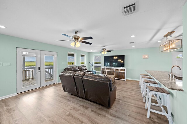 10102 S Redfish Dr, Hitchcock, TX 77563 - living area featuring french doors, light wood finished floors, recessed lighting, and ceiling fan