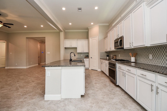 14618 Moccasin Ridge Dr, Cypress, TX 77433 - kitchen with stainless steel appliances, crown molding, ceiling fan, decorative backsplash, and dark stone countertops