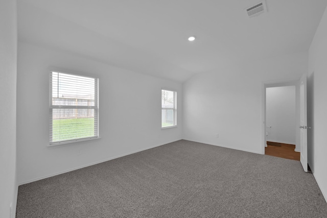 21391 Owl Rd, New Caney, TX 77357 - unfurnished room with dark colored carpet, lofted ceiling, and recessed lighting