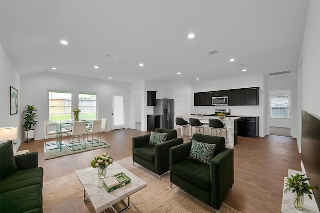 21391 Owl Rd, New Caney, TX 77357 - living area featuring wood finished floors, recessed lighting, and vaulted ceiling