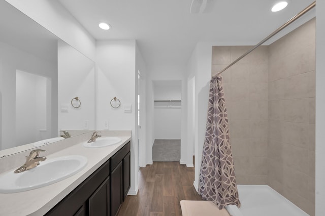 21391 Owl Rd, New Caney, TX 77357 - full bath with tiled shower, double vanity, wood finished floors, recessed lighting, and a walk in closet