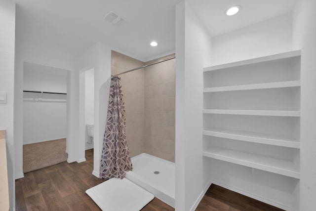 21391 Owl Rd, New Caney, TX 77357 - bathroom with a stall shower, a spacious closet, and wood finished floors