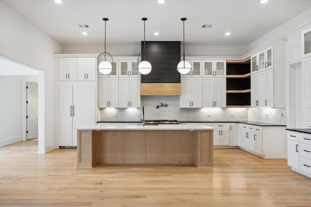 1419 Candlelight Ln, Houston, TX 77018 - kitchen with backsplash, light wood-style flooring, ventilation hood, and recessed lighting