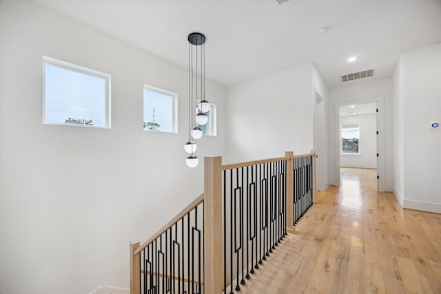 1419 Candlelight Ln, Houston, TX 77018 - hallway featuring light wood-style floors and an upstairs landing