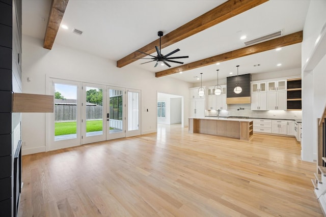 1419 Candlelight Ln, Houston, TX 77018 - unfurnished living room with a ceiling fan, beam ceiling, and light wood-type flooring