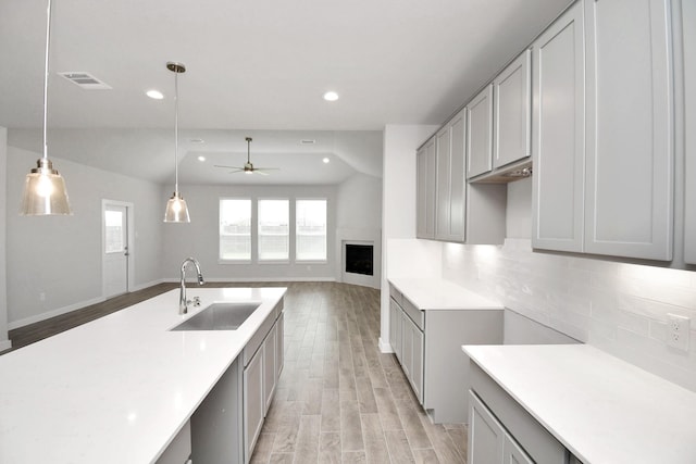 11106 Crocus Dr, Houston, TX 77044 - kitchen with a ceiling fan, light wood-type flooring, tasteful backsplash, recessed lighting, and light countertops