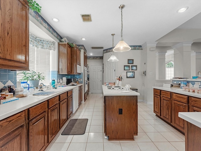 13410 Spyglen Ct, Cypress, TX 77429 - kitchen with a center island, backsplash, brown cabinets, light countertops, and recessed lighting