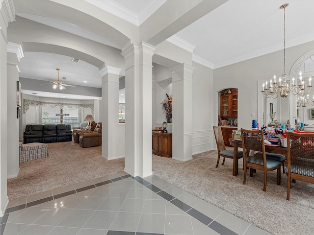 13410 Spyglen Ct, Cypress, TX 77429 - carpeted dining space featuring a ceiling fan, tile patterned floors, ornate columns, arched walkways, and ornamental molding