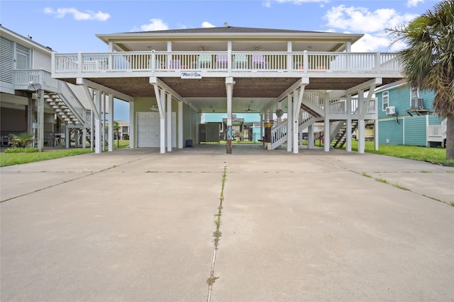 956 Biscayne, Crystal Beach, TX 77650 - beach home featuring a carport, stairway, a garage, driveway, and a porch