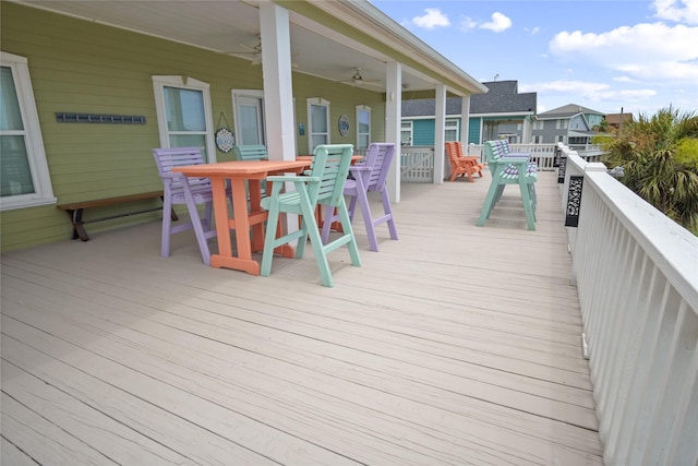 956 Biscayne, Crystal Beach, TX 77650 - wooden terrace with outdoor dining area and ceiling fan