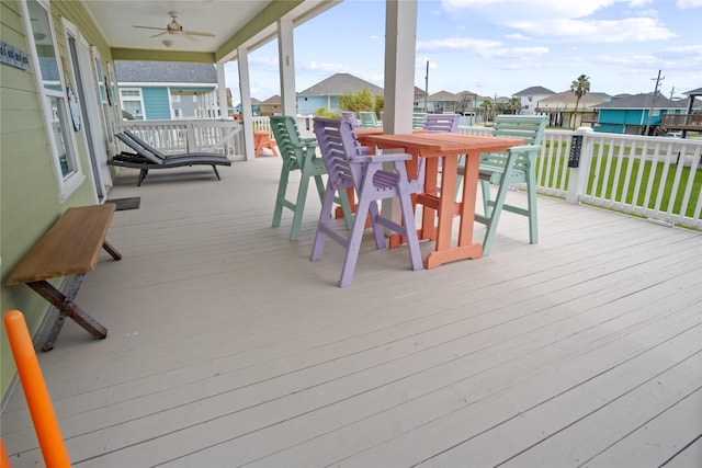 956 Biscayne, Crystal Beach, TX 77650 - wooden terrace featuring a ceiling fan, a residential view, and outdoor dining area