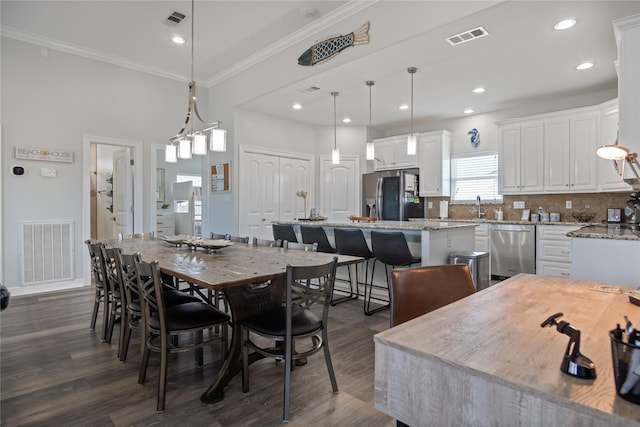 956 Biscayne, Crystal Beach, TX 77650 - dining room featuring ornamental molding, dark wood-style flooring, and recessed lighting
