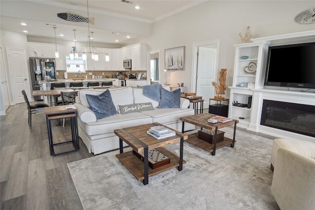 956 Biscayne, Crystal Beach, TX 77650 - living area with crown molding, light wood-style flooring, and recessed lighting