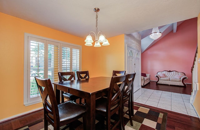 15731 Oak Mountain Dr, Houston, TX 77095 - dining area featuring wood finished floors, a chandelier, and lofted ceiling