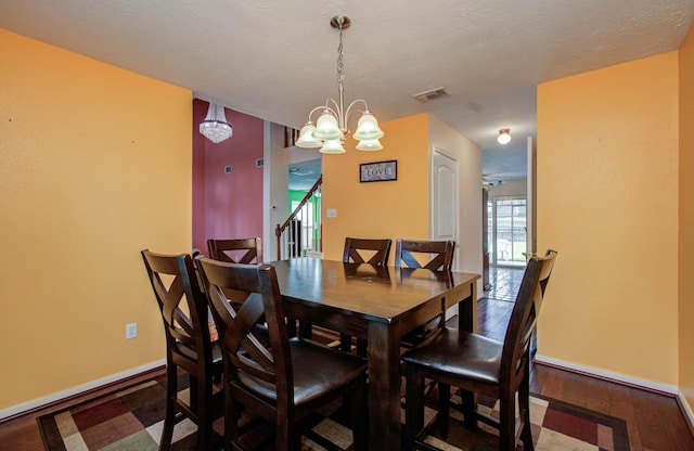 15731 Oak Mountain Dr, Houston, TX 77095 - dining room featuring a chandelier, dark wood-style flooring, and stairs